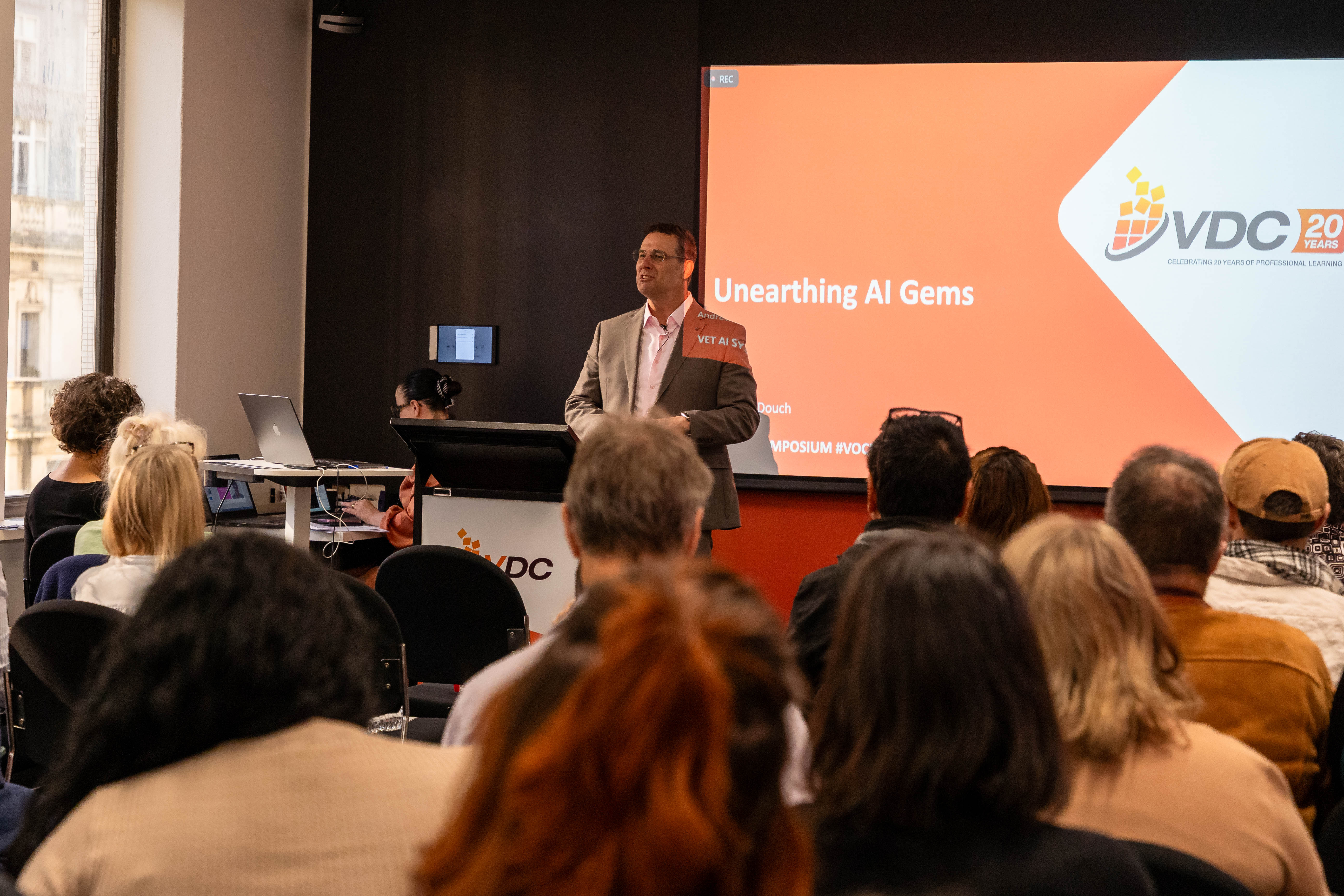 Andrew presenting an AI keynote to a professional audience