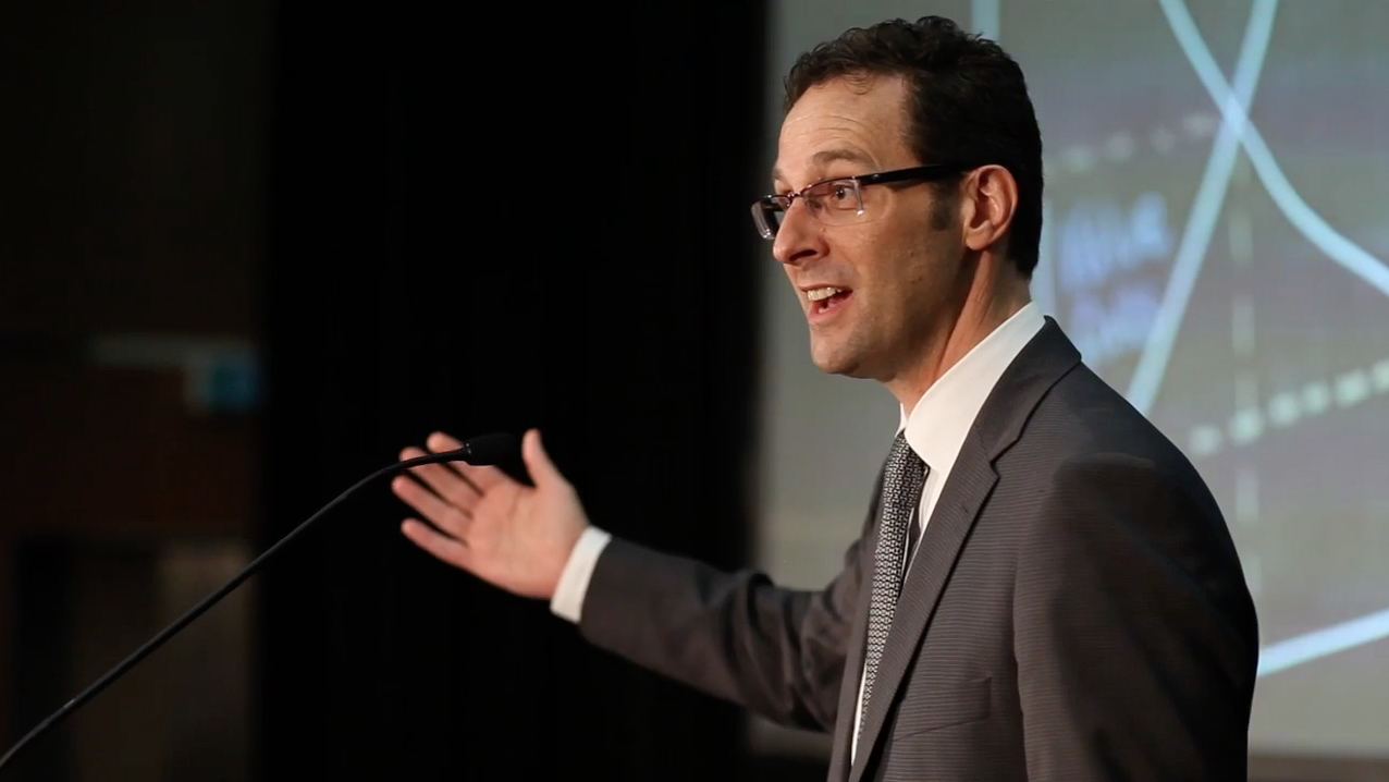 Andrew Douch speaking from a lectern